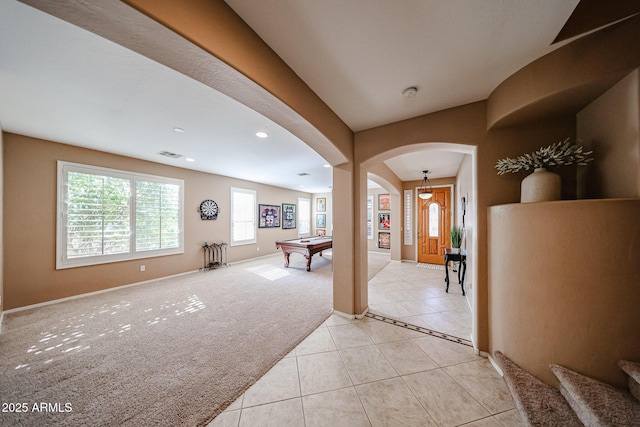 2886 E Hazeltine Way, Chandler, AZ 85249 - entryway with light tile patterned flooring, light colored carpet, arched walkways, pool table, and visible vents