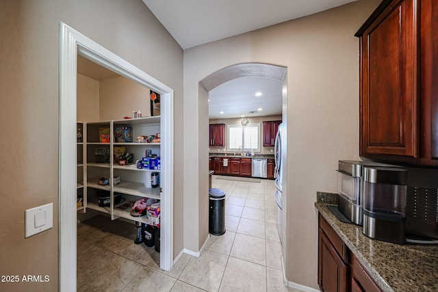 2886 E Hazeltine Way, Chandler, AZ 85249 - hallway featuring light tile patterned floors, arched walkways, recessed lighting, and a sink
