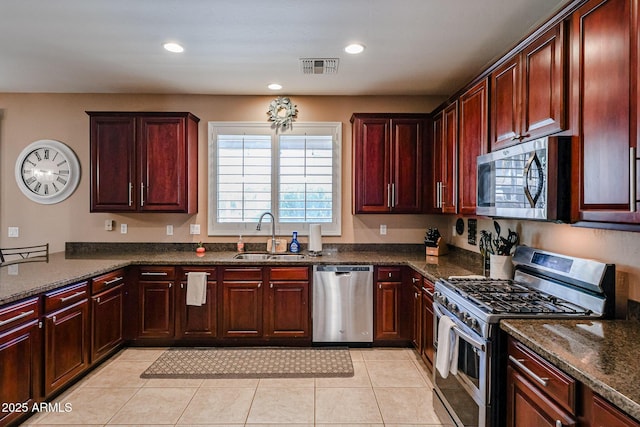 2886 E Hazeltine Way, Chandler, AZ 85249 - kitchen with visible vents, a sink, appliances with stainless steel finishes, and reddish brown cabinets
