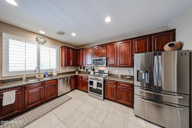 2886 E Hazeltine Way, Chandler, AZ 85249 - kitchen with visible vents, reddish brown cabinets, recessed lighting, a sink, and appliances with stainless steel finishes