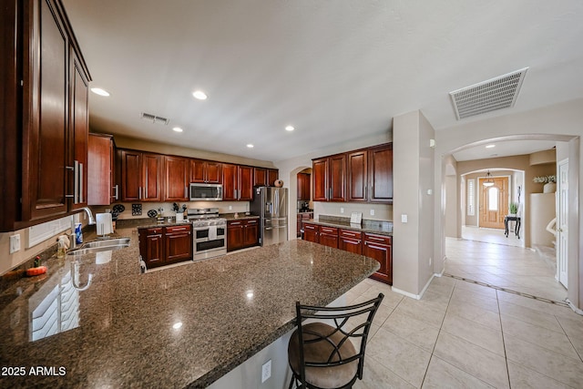 2886 E Hazeltine Way, Chandler, AZ 85249 - kitchen featuring arched walkways, visible vents, a sink, and stainless steel appliances