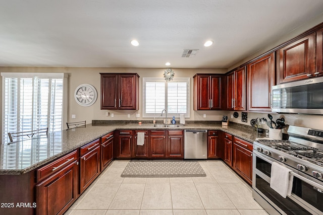 2886 E Hazeltine Way, Chandler, AZ 85249 - kitchen featuring stainless steel appliances, visible vents, a sink, and dark brown cabinets
