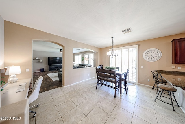 2886 E Hazeltine Way, Chandler, AZ 85249 - dining room with arched walkways, baseboards, visible vents, and light tile patterned flooring