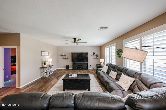 2886 E Hazeltine Way, Chandler, AZ 85249 - living room with visible vents, a ceiling fan, baseboards, and wood finished floors