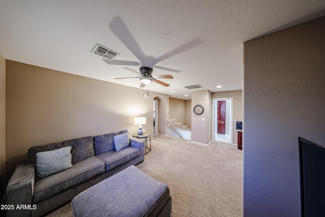 2886 E Hazeltine Way, Chandler, AZ 85249 - living room featuring carpet floors, ceiling fan, arched walkways, and visible vents
