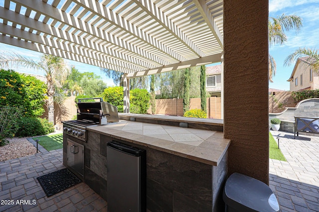 2886 E Hazeltine Way, Chandler, AZ 85249 - view of patio featuring exterior kitchen, a fenced backyard, a pergola, and a grill