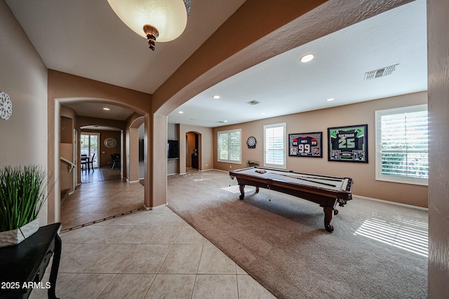 2886 E Hazeltine Way, Chandler, AZ 85249 - rec room featuring a healthy amount of sunlight, visible vents, arched walkways, light tile patterned floors, and light carpet
