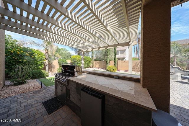 2886 E Hazeltine Way, Chandler, AZ 85249 - view of patio / terrace with area for grilling, an outdoor kitchen, fence, and a pergola