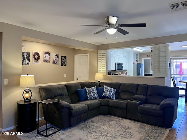 6049 S Wilson Dr, Chandler, AZ 85249 - living room featuring a ceiling fan and baseboards