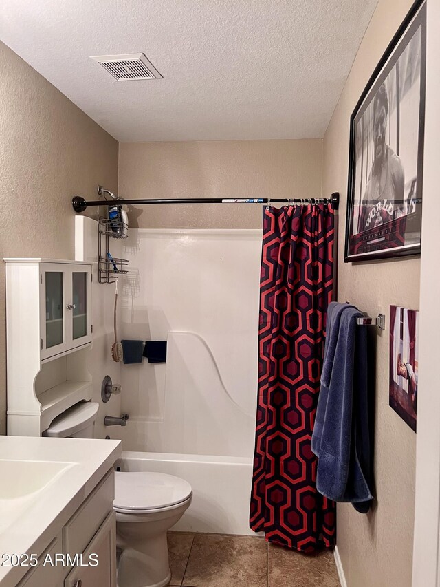 6049 S Wilson Dr, Chandler, AZ 85249 - full bathroom with a textured wall, toilet, tile patterned floors, vanity, and shower / tub combo