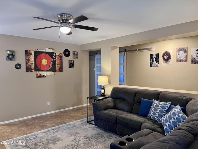 6049 S Wilson Dr, Chandler, AZ 85249 - living area with ceiling fan, a barn door, and baseboards