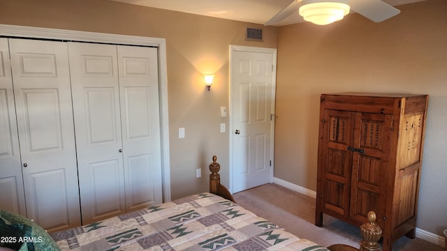 carpeted bedroom with ceiling fan and a closet