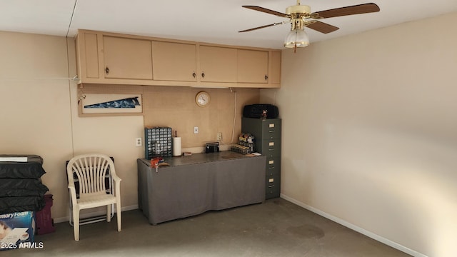 kitchen with ceiling fan, concrete floors, and cream cabinetry