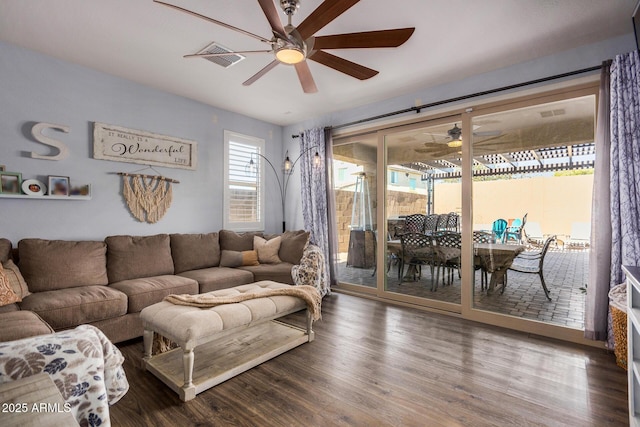 living room with ceiling fan and dark wood-type flooring