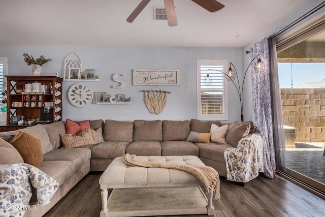 living room with ceiling fan and dark hardwood / wood-style flooring