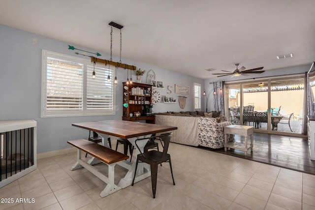 dining room with a wealth of natural light, ceiling fan, and light tile patterned floors