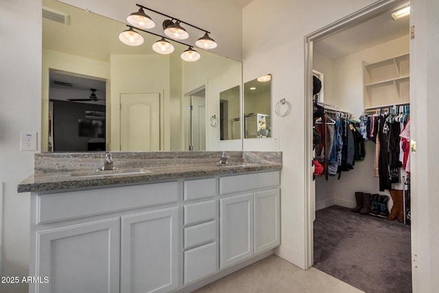 bathroom featuring tile patterned flooring, ceiling fan, and vanity