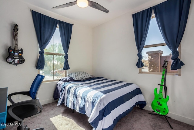 bedroom featuring ceiling fan and carpet