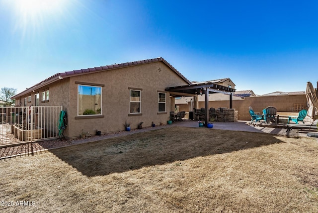 rear view of property featuring an outdoor fire pit, a patio area, and a lawn