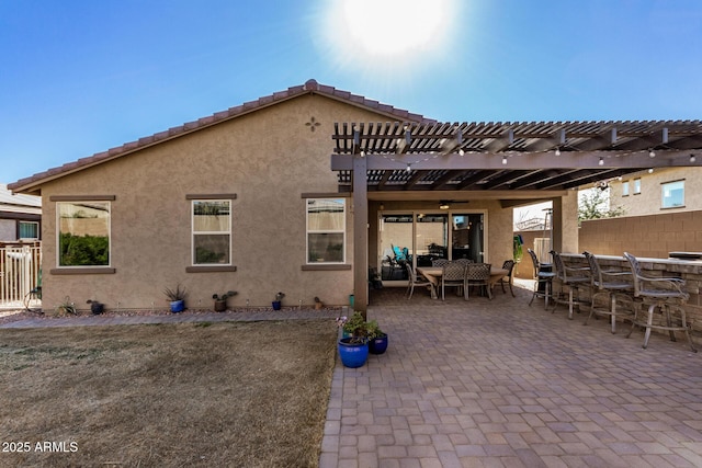 back of house with a patio area, exterior bar, and a pergola