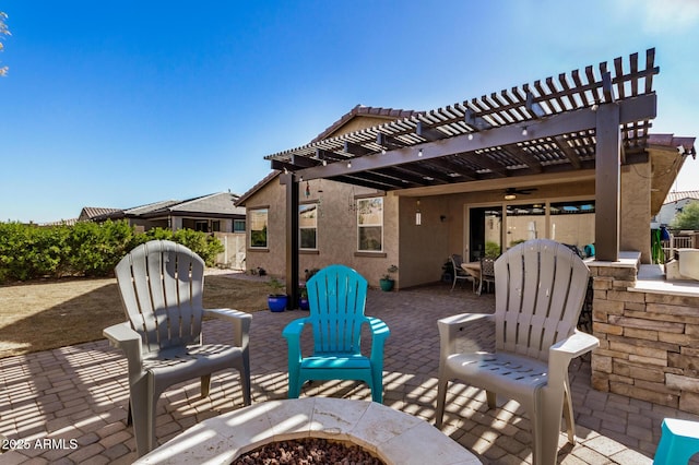 view of patio / terrace featuring a fire pit, ceiling fan, and a pergola