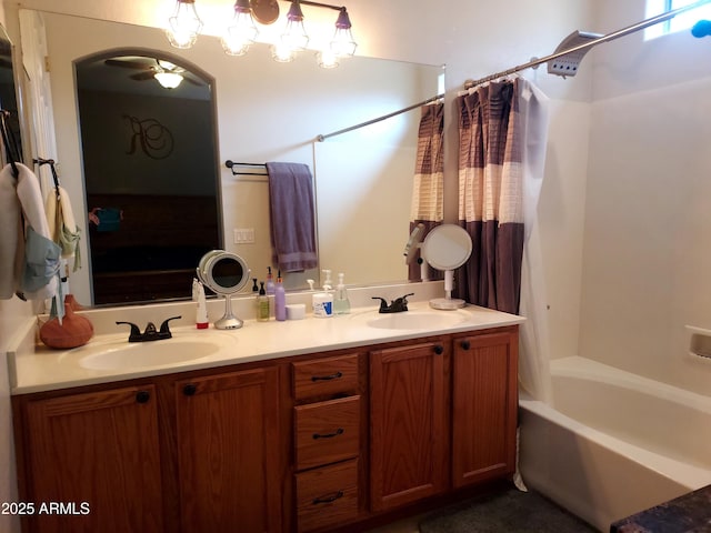 bathroom featuring double vanity, a sink, and shower / bath combo with shower curtain