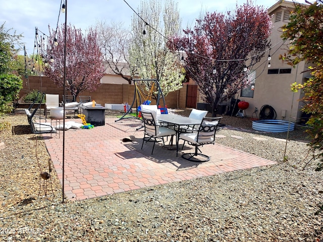view of patio / terrace featuring a fire pit and a fenced backyard