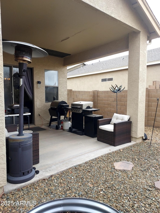 view of patio / terrace featuring grilling area, fence, and visible vents