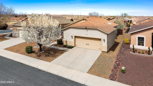 single story home with a garage, a residential view, driveway, and stucco siding