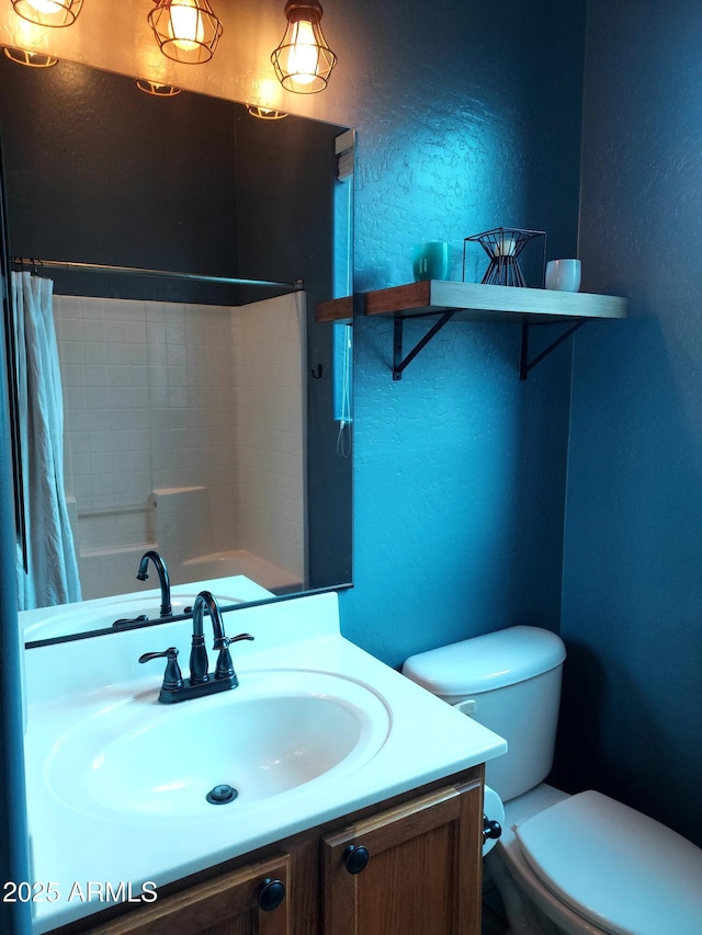 bathroom with toilet, curtained shower, vanity, and a textured wall