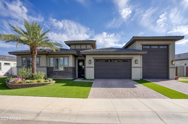 18175 W Highland Ave, Goodyear, AZ 85395 - prairie-style house with a garage, stucco siding, driveway, and a front yard
