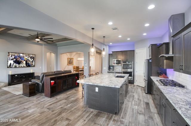 18175 W Highland Ave, Goodyear, AZ 85395 - kitchen with visible vents, a sink, open floor plan, arched walkways, and stainless steel appliances