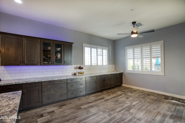 18175 W Highland Ave, Goodyear, AZ 85395 - kitchen with visible vents, ceiling fan, wood finished floors, and dark brown cabinets