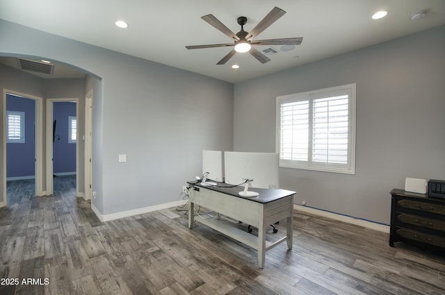 18175 W Highland Ave, Goodyear, AZ 85395 - home office with arched walkways, ceiling fan, a wealth of natural light, and visible vents