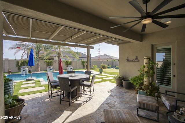 18175 W Highland Ave, Goodyear, AZ 85395 - view of patio / terrace with a fenced in pool, a ceiling fan, outdoor dining space, and a fenced backyard
