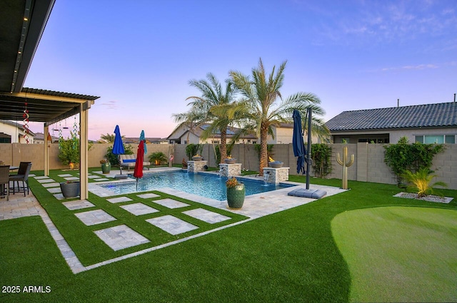 18175 W Highland Ave, Goodyear, AZ 85395 - pool at dusk featuring a yard, a patio, a fenced in pool, and a fenced backyard