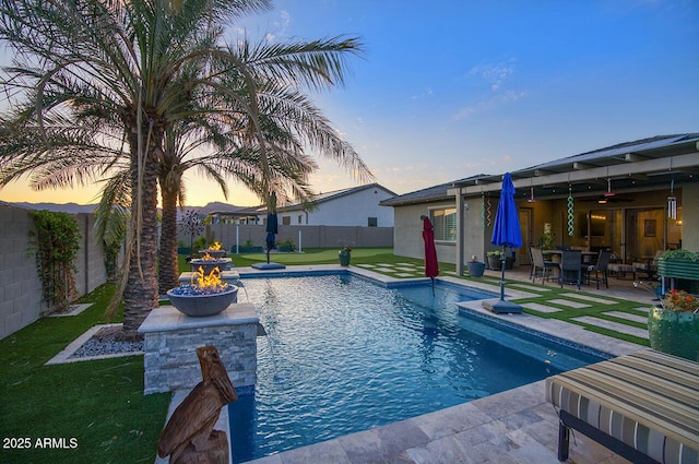 18175 W Highland Ave, Goodyear, AZ 85395 - view of swimming pool with a ceiling fan, a lawn, a fenced in pool, a fenced backyard, and a patio
