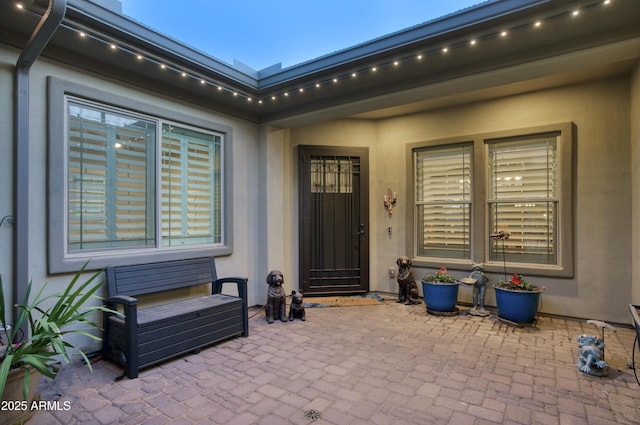18175 W Highland Ave, Goodyear, AZ 85395 - doorway to property featuring stucco siding and a patio area