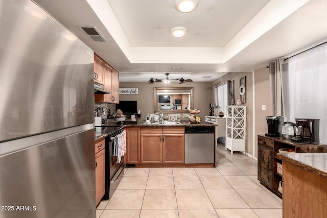 19258 N 20th Dr, Phoenix, AZ 85027 - kitchen featuring a peninsula, a raised ceiling, appliances with stainless steel finishes, a sink, and light tile patterned floors