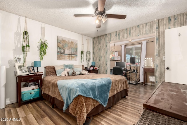 19258 N 20th Dr, Phoenix, AZ 85027 - bedroom featuring baseboards, a textured ceiling, wallpapered walls, and wood finished floors
