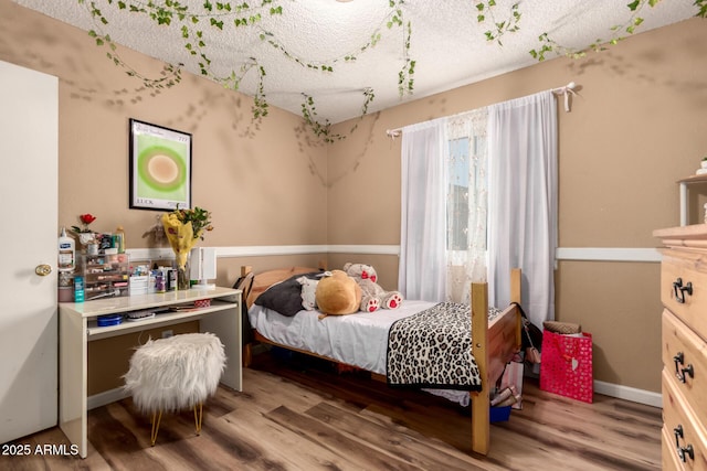 19258 N 20th Dr, Phoenix, AZ 85027 - bedroom with wood finished floors and a textured ceiling