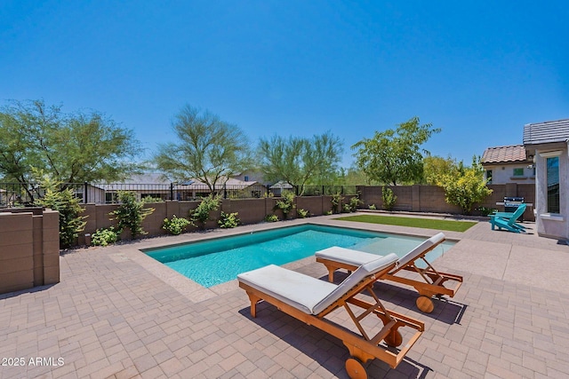 view of swimming pool with a patio and a fenced backyard