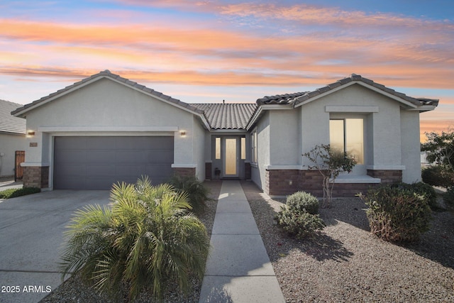 ranch-style home featuring stone siding, driveway, an attached garage, and stucco siding