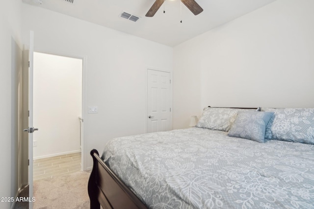 bedroom featuring light carpet, visible vents, and a ceiling fan