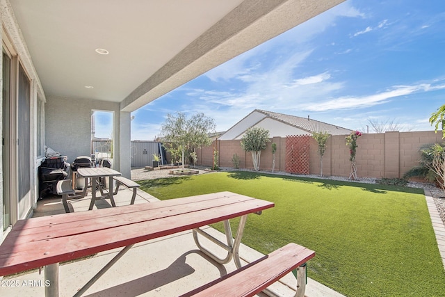 exterior space featuring a fenced backyard and a patio