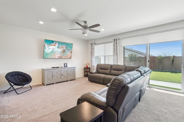 living area with a ceiling fan, recessed lighting, light colored carpet, and baseboards