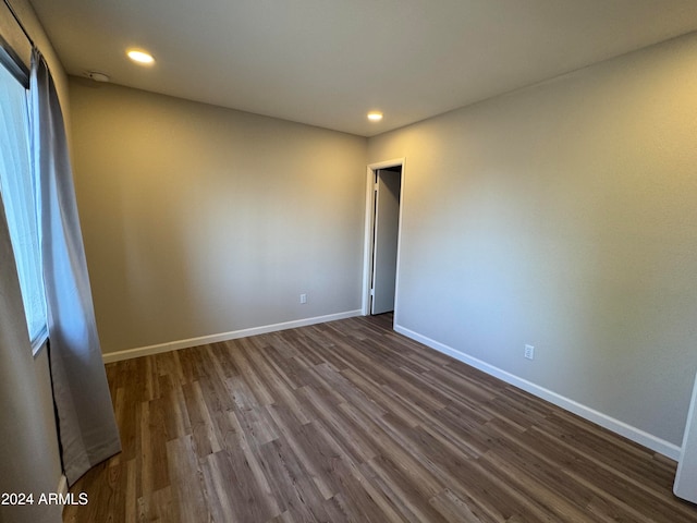 empty room featuring dark wood-type flooring