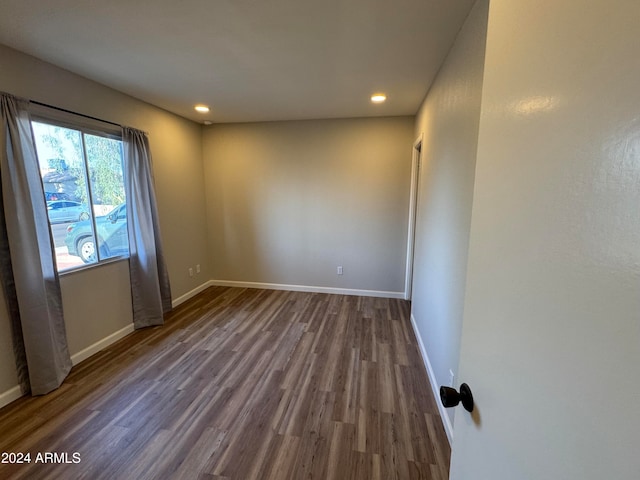 empty room with dark hardwood / wood-style flooring