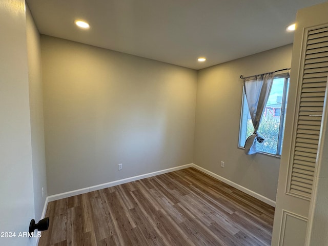 unfurnished room with hardwood / wood-style floors