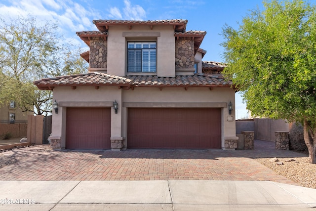 mediterranean / spanish home with a garage